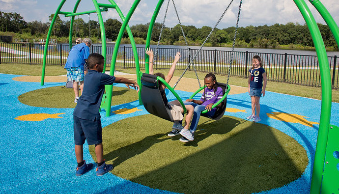 childing-playing-playground-grass-2 Children swinging and playing on Playground Grass synthetic turf at Carrollwood Community Park