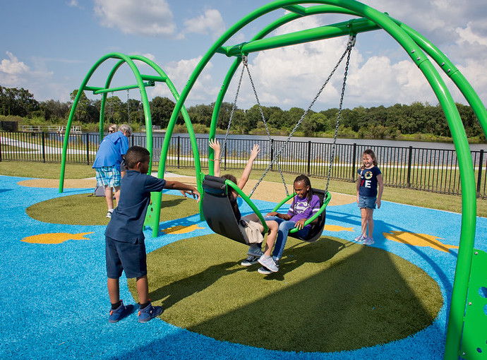 childing-playing-playground-grass Children swinging and playing on Playground Grass synthetic turf at Carrollwood Community Park