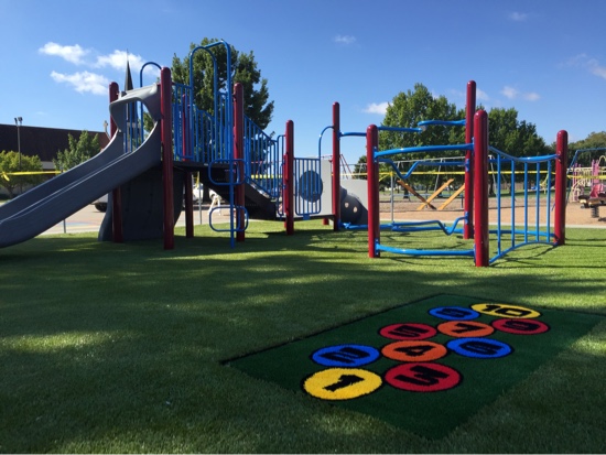 funserts in playground Playground at Holy Cross in Hutchinson, Kansas, featuring Playground Grass synthetic turf by ForeverLawn