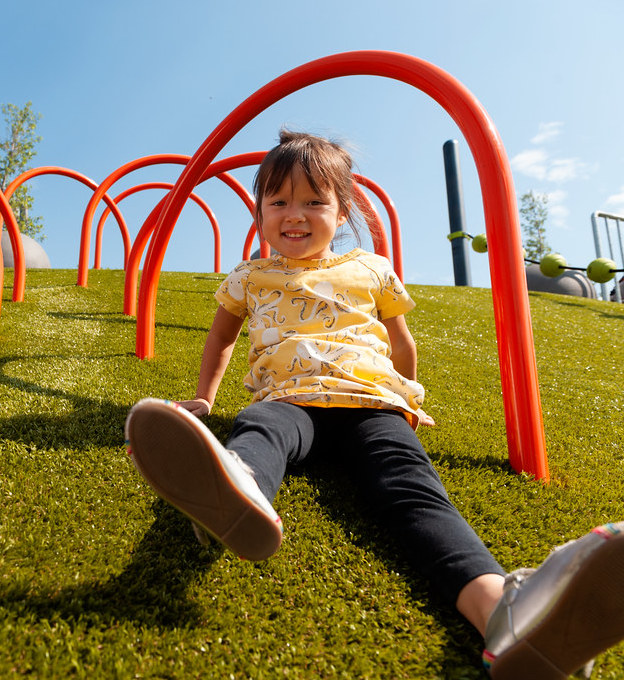 girl-on-playground-grass Girl playing on playground grass