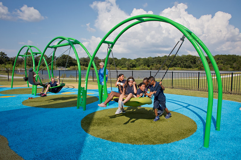 kids-on-swing Kids on swing in the middle of a circle design in Playground Grass synthetic turf
