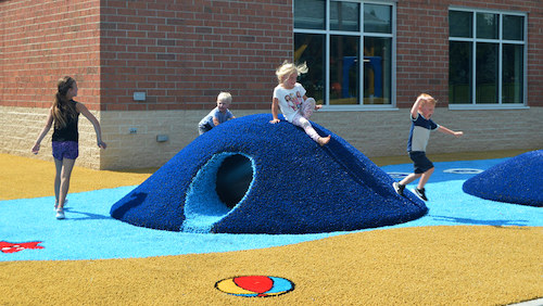 Playmounds-Poured-Rubber Playground Grass Playmound with children playing.