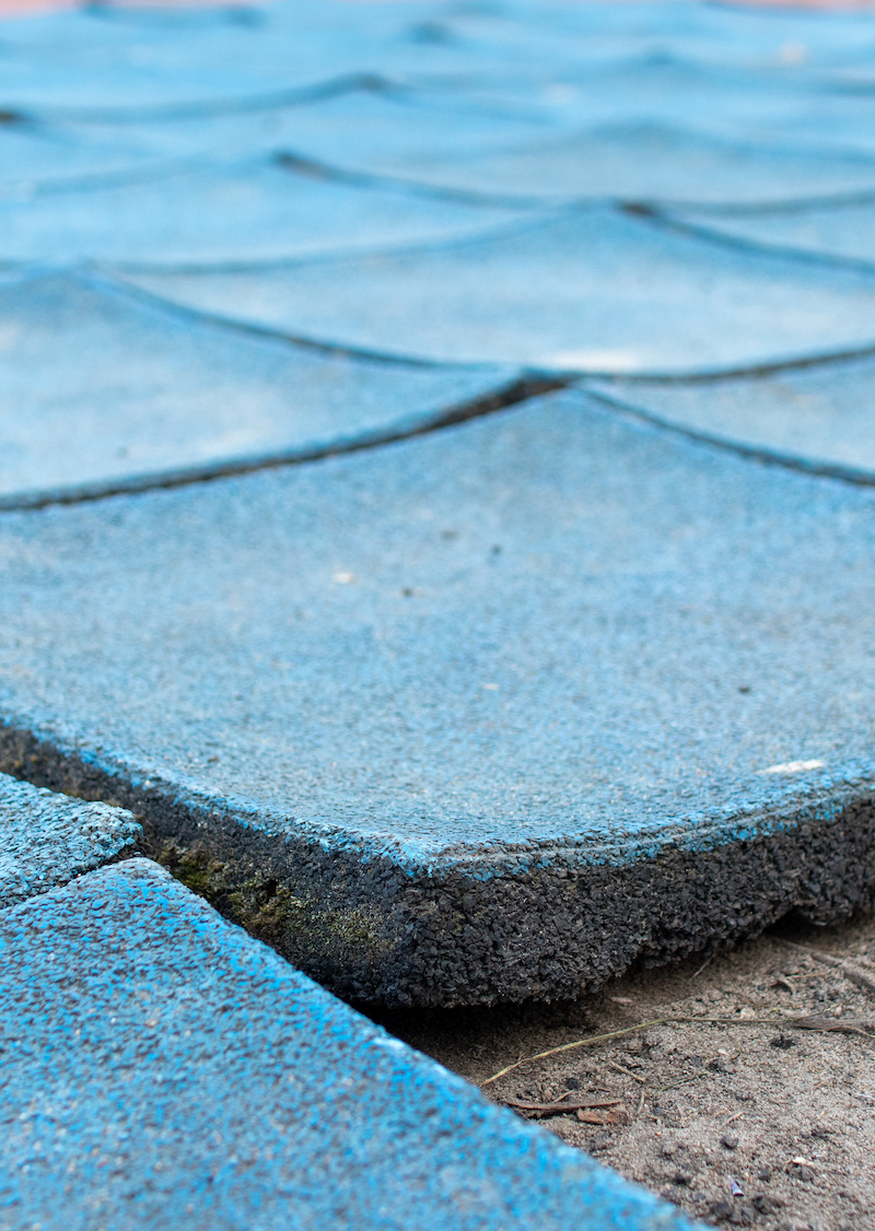 Broken,Rubber,Tiles,In,The,Playground,,Old,Poured-in-place,,Pip,,Tartan Rubber surface used for playgrounds.