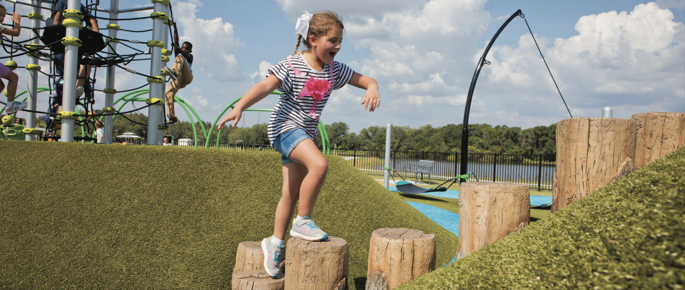 Girl running on playground grass